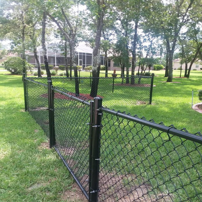 three foot tall chain link fence black enclosing a yard 
