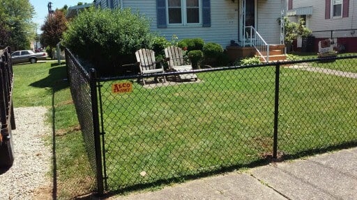 black chain linked fence three foot tall around a front yard 