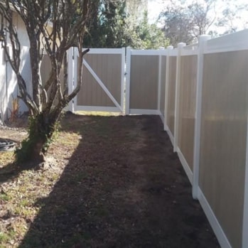 tan vinyl fence enclosing a yard